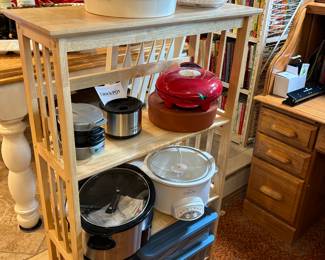 Wood shelving unit, crock pots, cook books, salad spinner, grill