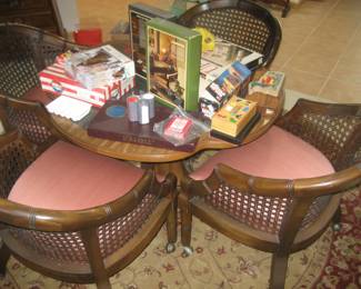 Game table, 4 rattan and upholstered chairs with castors, vintage games