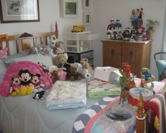 Child's bedroom with quilts, character dolls, stuffed animals