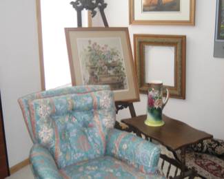 Upholstered chair, wood magazine side table, Victorian pitcher, carved easel, framed art