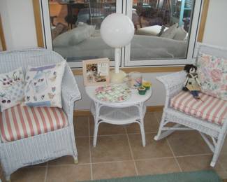 White wicker chair, rocker and table, decorative throw pillows