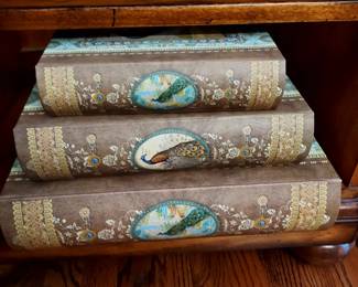 Three faux books storage boxes with peacock decor