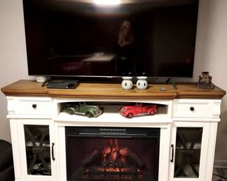Beautiful, excellent.working faux fireplace room heater and television stand. multi-purpose cabinet.   TV SOLD 