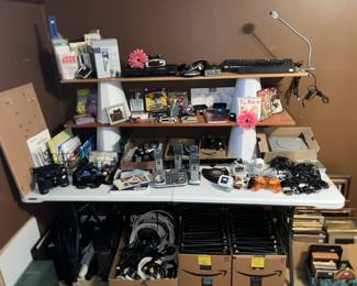 Table full of home office & small electronics