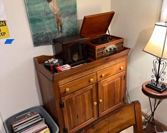 record player, radio, cupboard, records, and golfing art