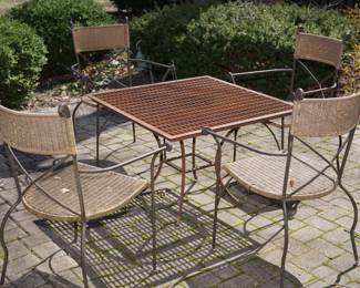 industrial floor grate made into a table top for patio table. comes off for easy load to your home