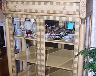 Painted display cabinet, cups and saucers