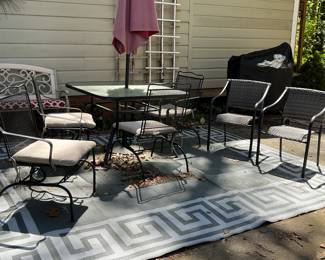 Metal umbrella table and 4 matching chairs, 2 matching chairs, outdoor rug.