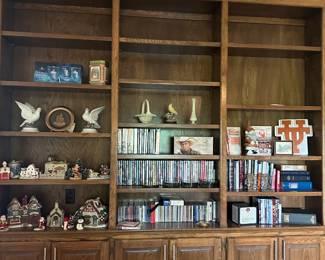 Built-in bookcases in living room with DVDs, CDs, Christmas Village houses, UT decor and other decor