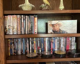 The top shelf has a couple Fenton custard / uranium glass pieces