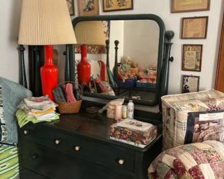 The twin bed is in the corner and the dresser is painted to match.