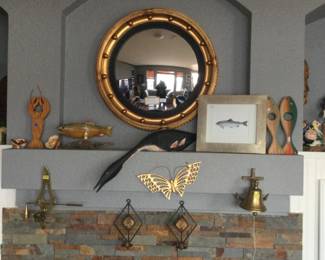 Round mirror, fishy things & candlesticks.