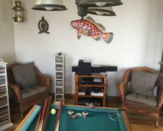 Pioneer DVD/CD player, sound bar & woofer. 2 wicker chairs w/ cushions, lots of DVD’s & CD’s. Hanging lights & fish on walls.