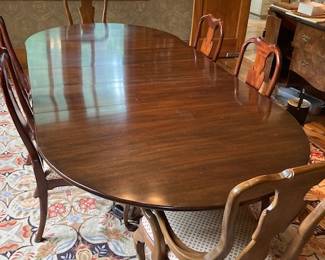 antique dining table, as shown with 2 leaves inserted. There are 12 chairs total, they are a good match, more contemporary