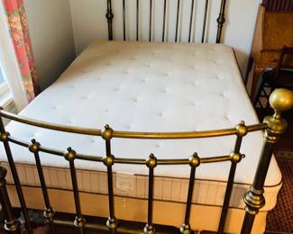 Antique brass bed with curved bow footboard