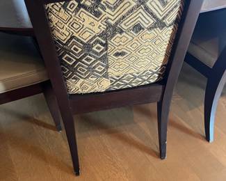 A backside view showing the Kuba cloth on the back of each chair.