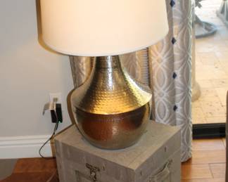 Contemporary hammered metal lamp - the trunk/end table underneath is wrapped in woven - very cool