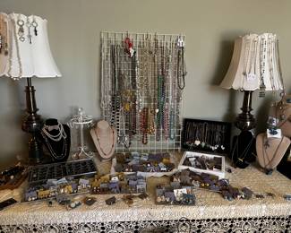 A room full of jewelry-earrings galore,  necklaces, pins, bracelets, crucifixes, etc.