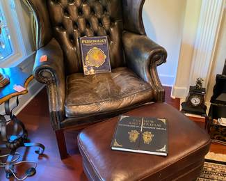#87 - $150 - Leather tuffed wingback chair (some damages) with ottoman (not a true match)