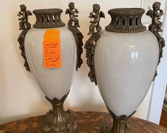 $80 - Pair of light grey urns with puttis 18H