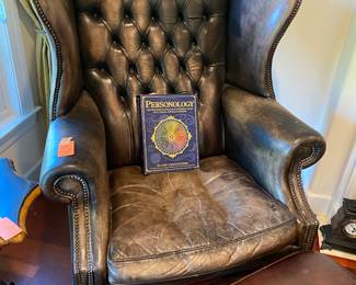 #87 - $150 - Leather tuffed wingback chair (some damages) with ottoman (not a true match)