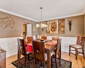 Step into a space of warmth and charm with our classic dining set. This elegant ensemble, ideal for gatherings and family dinners, features a solid wood table with a rich mahogany finish, complemented by six comfortable high-back chairs. Each chair is upholstered in a premium, durable fabric that invites guests to linger longer over meals. The set is framed by a beautifully crafted sideboard, perfect for displaying your fine china or cherished keepsakes. Complete with a gracefully hanging chandelier, this dining set will be the heart of your home where memories are made. A harmony of style and function awaits your dining pleasure. BEST OFFER 