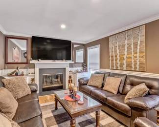 Step into comfort with this inviting living room set, perfect for cozy evenings or entertaining friends and family. The plush leather sofa offers ample seating, complemented by a matching loveseat, both in a rich chocolate hue that adds warmth to the room. The centerpiece is a classic glass-top coffee table, ideal for holding your refreshments or favorite books. Positioned around a charming fireplace, this set creates a focal point for relaxation and socializing. Accentuated by an artful wall piece, the space is a harmonious blend of comfort and contemporary elegance BEST OFFER