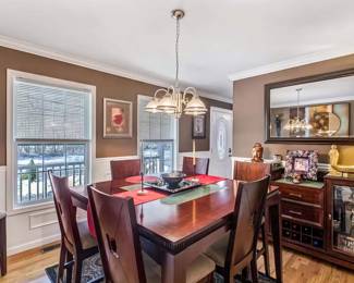 Dine in elegance with this beautifully crafted dining set, featuring a sleek table that comfortably seats six. Each chair, with its high back and cushioned seating, is designed for prolonged comfort and sophisticated dinner conversations. The set is accompanied by a stunning china cabinet, perfect for displaying your treasured dishware and collectibles. Overhead, a tasteful chandelier casts a warm glow, enhancing every meal with a touch of ambience. This set promises to be the centerpiece of many memorable gatherings. BEST OFFER