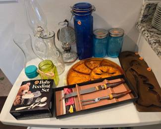 A few vintage items - carving set, baby utencils, copper wall hangings, amber platter, oil lamps