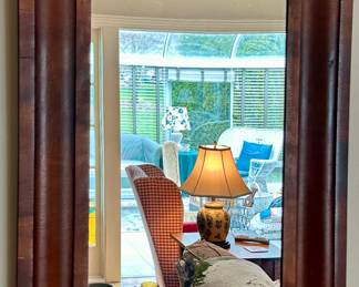 This Antique Mirror has a Rich Wood Frame that would fit for any decor