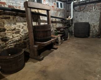 Wine barrels, wine press, grape crusher. 