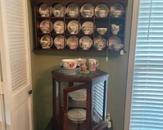 Tea cup and saucer collection.  Beatrice Potter Bunny plates and cups,   Cup/Saucer wall unit, display cabinet, Wine Bottle cabinet.