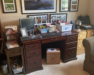Office includes desk, Bibles, books, filing cabinets, photography wall art