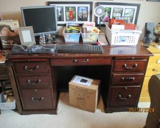 Computer desk.  Has pull down center drawer for keyboard, 2 slide out rests for paper or books.