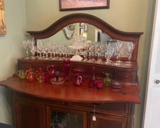 Buffet with fold out serving extension.  Crystal glasses and 'red' glass collectibles.  
