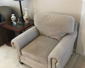 This chair matches the 3 cushion couch! Both have nail head trim! Glass topped end tables (2) also have a matching coffee table! There is also  a Pair of Black candlestick lamps!