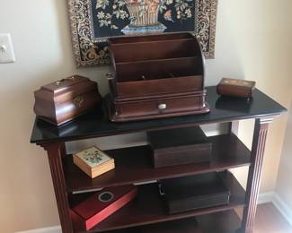 Entry way table displayed with trinket and jewelry boxes! Nice wall tapestry on the wall!