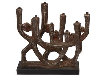 3201
Klara Sever (1935-2021)
A Brutalist Austin Productions menorah designed by Klara Sever, 1975
Incised along the base: K Sever; further marked: Austin Productions © 1975
The cast faux metal finish plaster Menorah with brachial design interspersed with circular swirl motifs on a painted wood base
14.5" H x 16.25" W x 4.25" D
Estimate: $100 - $200
