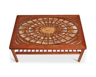 3184
Mid-20th century
A Danish Teak Wood Coffee Table
Stamped to underside: Made in Denmark by Møbelfabrikken Toften
The wood table with inset painted and glazed ceramic tiles assembled in a sunburst pattern, above a slatted undershelf
18" H x 44.25" W x 28.5" D
Estimate: $400 - $600