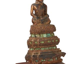 3112
Circa 1900; Myanmar
A Burmese Carved Wood Seated Buddha
The lacquered and gilt carved wood seated Buddha on a lotus over a tiered throne adorned with inlaid polychrome glass, mounted to a wood base
Overall: 18" H x 10.25" W x 7.25" D
Estimate: $800 - $1,200