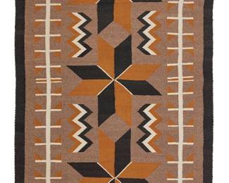 3153
A Navajo Regional Rug
Mid-20th century, Diné
Woven in brown, black, ochre, and cream wool with three central Vallero star motifs and long hooked motifs to sides
53" H x 33" W
Estimate: $200 - $400