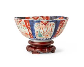 3109
Meiji period 1868-1912
A Japanese Imari Porcelain Bowl
Unmarked
The painted porcelain bowl with scalloped rim, depicting various garden scenes in friezes, set on a carved wood stand
Bowl: 4.125" H x 9.75" Dia.; Stand: 2" H x 5.125" Dia.
Estimate: $100 - $200