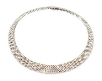 3041
A White Gold Collar Necklace
Woven design, in 14K white gold

52.8 grams gross
14" L
Estimate: $1,000 - $2,000