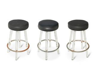 3178
Mid/late 20th century
Three Lucite And Chrome Bar Stools
Each appears unmarked
Each with a black Naugahyde swivel seat raised on clear Lucite tubular legs with a chrome foot rail, 3 pieces
Each: 29" H x 19.25" Dia.
Estimate: $200 - $300