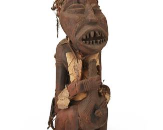3163
Late 19th/early 20th century; Congo
A Songye Power Figure
The carved wood figure adorned with a hide vest, shells tied on braided fiber threads, a necklace with carved bone mask pendant, and a headpiece of woven fibers and applied feathers
25.5" H x 8.5" W x 10" D
Estimate: $400 - $600