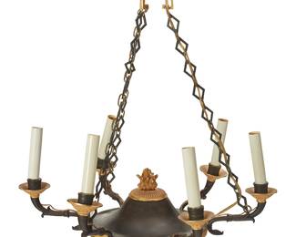 3117
Early 20th century
A French Empire-Style Chandelier
Stamped to the mount: LB 1164
The six-light chandelier with six patinated and gilt-bronze Florentine dolphin and foliate motif arms, each surmounted by a faux candle light, radiating from a central medallion with an eternal flame finial to the top and pinecone finial to the bottom; suspended by three geometric linked chains, electrified
23.5" H x 20" Dia.
Estimate: $300 - $500