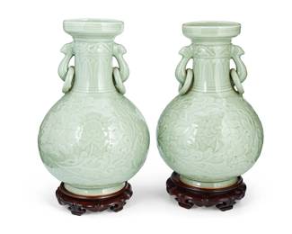 3106
20th century
A Pair Of Chinese Celadon Handled Vases
Each appears unmarked
Each glazed double-handled ceramic vase with rings and low relief lotus scroll motifs, along with a carved wood base, 2 pieces
Each with base: 16.5" H x 9.5" Dia.
Estimate: $200 - $400