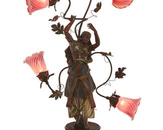 3116
Early/mid-20th century
An Art Nouveau Patinated Metal Figural Lamp
Appears unmarked
The lamp in the manner of Auguste Moreau (1834-1917), depicting an Orientalist figure of a dancing woman issuing vines terminating in four foliate lights fitted with magenta glass shades, raised on a metal and wood base, electrified
Overall: 41" H x 26.5" W x 13" D
Estimate: $500 - $700