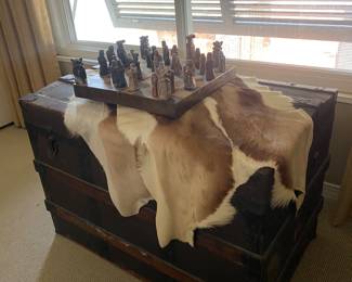 Antique trunk, hide rug , chess set