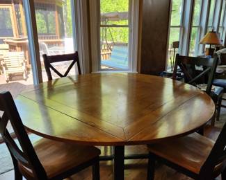 HEAVY wood dining set. Table sides fold to make it square or round.  Comes with 6 heavy chairs.